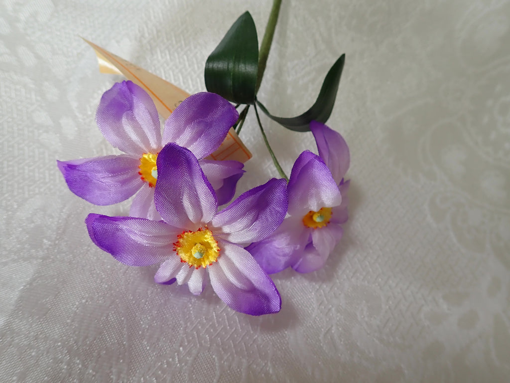 Six stems of Vintage millinery flowers. Purple anemones with yellow center and green leaves.